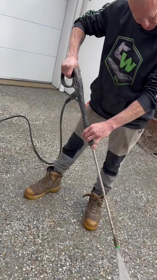 ConcreteWorX team pressure washing an exposed aggregate concrete surface